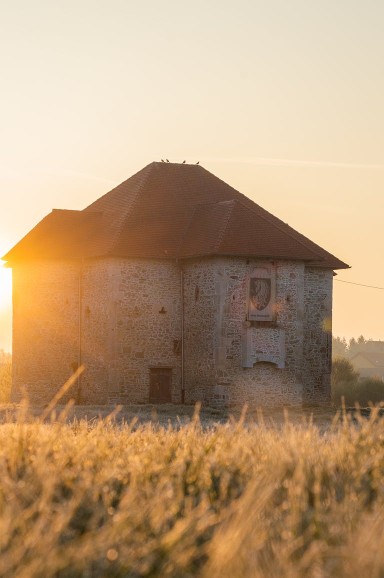 Charming stone building in Konjšćina, Croatia, beautifully illuminated by the sunrise. Perfect for travel and architecture themes.