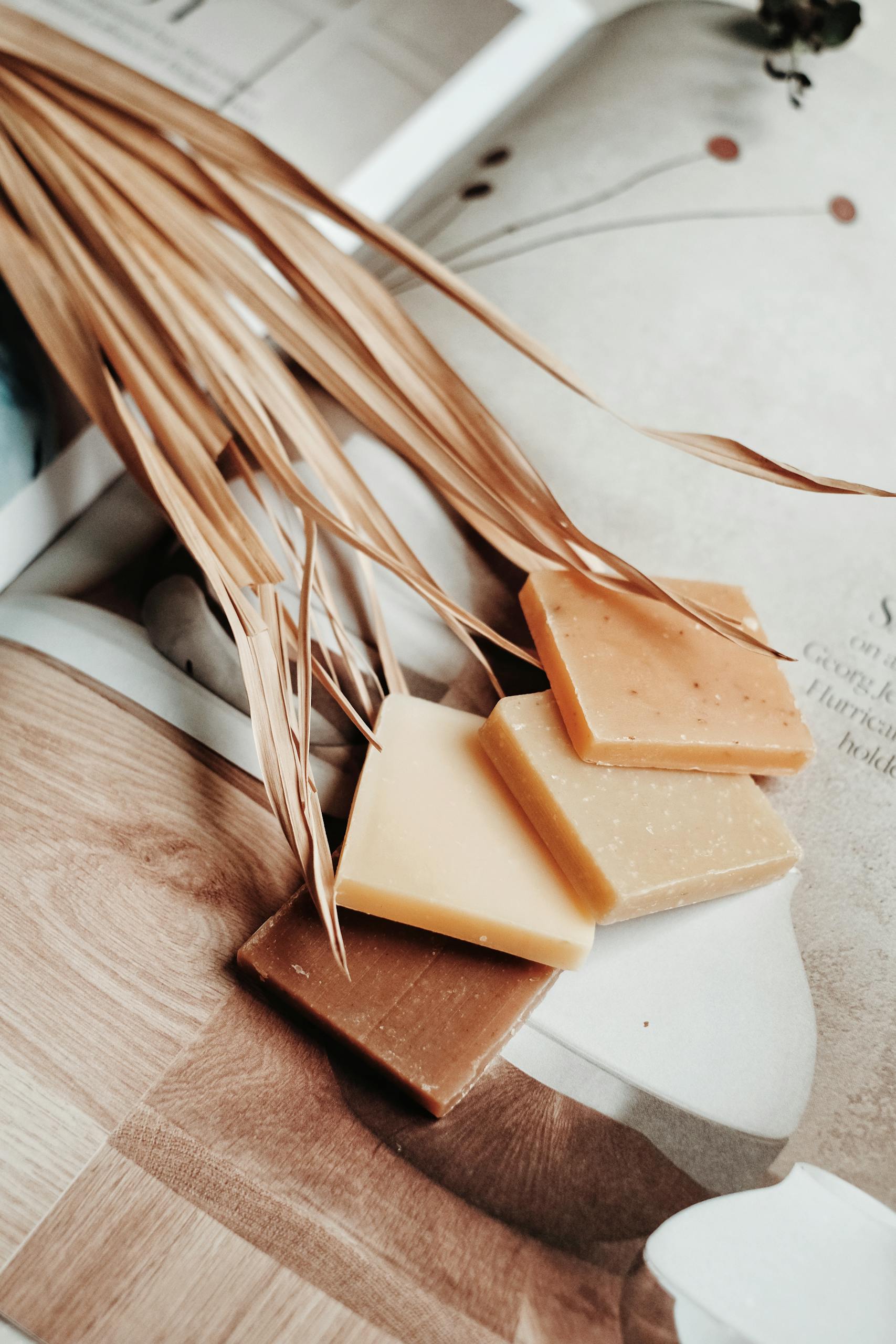 Elegant display of natural bar soaps on a magazine with eco-friendly vibes.