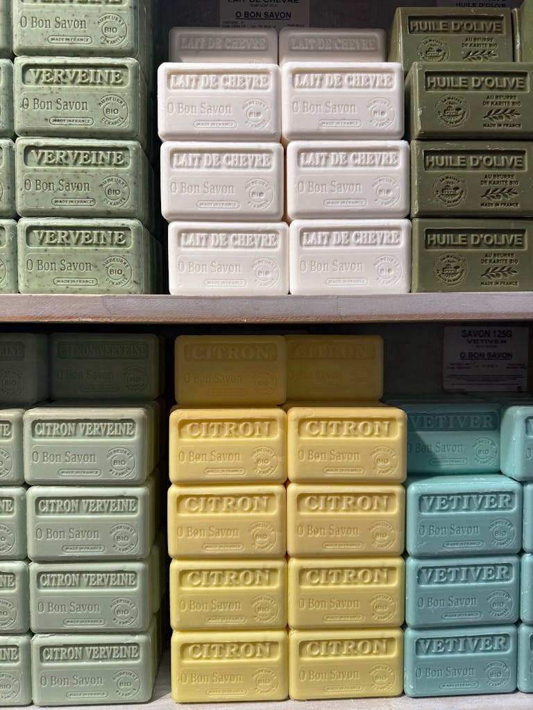 Various scented soap bars arranged neatly on shelves in a store display.